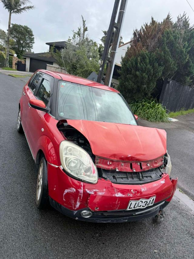 Red hatchback with front-end crash damage bought for cash