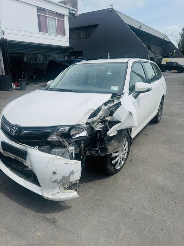 Toyota wagon with front damage awaiting collection in Dunedin