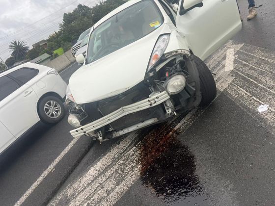 White car with heavy front-end crash damage awaiting removal in Dunedin
